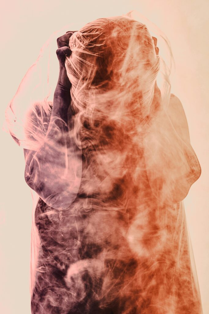 An image of a person blurred in wisps of smoke, representing anxiety.